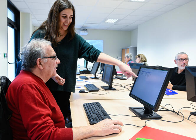 Une conseillère donne un cours d’informatique à des seniors, pour les aider dans leurs démarches administratives, à Mornant (Rhône), en janvier 2020.
