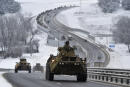 FILE - A convoy of Russian armored vehicles moves along a highway in Crimea, Tuesday, Jan. 18, 2022. Russia has concentrated an estimated 100,000 troops with tanks and other heavy weapons near Ukraine in what the West fears could be a prelude to an invasion. Germany's refusal to join other NATO members in supplying Ukraine with weapons has frustrated allies and prompted some to question Berlin's resolve in standing up to Russia. (AP Photo, File)
