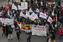 Demonstrators, workers and students march during a protest for salary increase, in Paris, France, Thursday, Jan. 27, 2022. Demonstrations and marches have been scheduled across France as cross-sector workers demand salary hike to cope with the spiraling cost of living. (AP Photo/Francois Mori)
