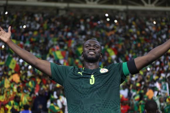 Kouyaté déploie ses bras près des tribunes.
