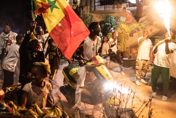 Supporters celebrate in Dakar on January 06, 2022, after Senegal won the Africa Cup of Nation (CAN) final against Egypt in Yaounde, Cameroon.. (Photo by JOHN WESSELS / AFP)