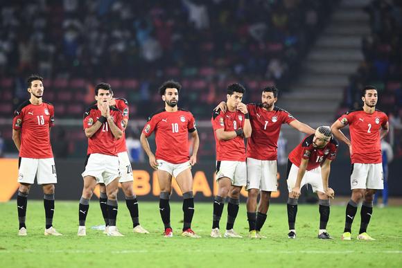 Egypt's players reacts in a penalty shoot-out during the Africa Cup of Nations (CAN) 2021 final football match between Senegal and Egypt at Stade d'Olembe in Yaounde on February 6, 2022. (Photo by CHARLY TRIBALLEAU / AFP)