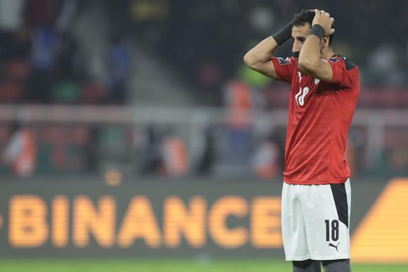 Egypt's midfielder Mohanad Mostafa Lasheen reacts after missing a shot during a penalty shoot-out as part of the Africa Cup of Nations (CAN) 2021 final football match between Senegal and Egypt at Stade d'Olembe in Yaounde on February 6, 2022. (Photo by Kenzo TRIBOUILLARD / AFP)