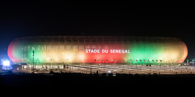 Le nouveau stade sénégalais éclairé aux couleurs nationales, dans la ville nouvelle de Diamniadio, à une trentaine de kilomètres à l’est de Dakar, le 22 janvier 2022.
