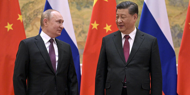 FILE - Chinese President Xi Jinping, right, and Russian President Vladimir Putin talk to each other during their meeting in Beijing, Feb. 4, 2022. China on Thursday, March 3, 2022, denounced a report that it asked Russia to delay invading Ukraine until after the Beijing Winter Olympics as 