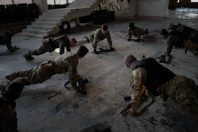 Young recruits from the Lobart Battalion take part in a training exercise at an abandoned Soviet building in Ukraine on March 20, 2022.