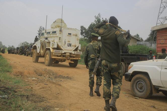 DRC and MONUSCO soldiers escort civilians on a road between Beni and Komanda on March 19, 2022.