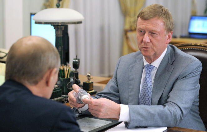 Then-Prime Minister Vladimir Putin (rear) speaks with Rusnano state-owned company CEO Anatoly Chubais as they meet at a residence in Novo-Ogaryovo, outside Moscow, on August 18, 2011.