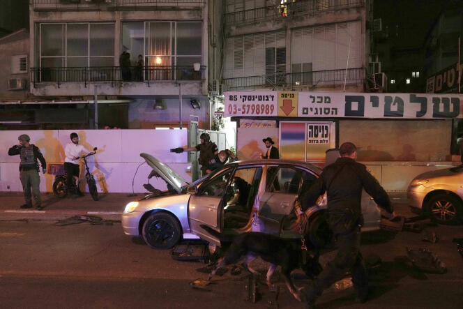 Israeli police inspect the site of the attack in the suburbs of Tel Aviv on March 29, 2022.