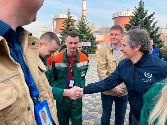 International Atomic Energy Agency (IAEA) Director-General Rafael Grossi shakes hands with an employee of the southern Ukraine nuclear power plant, Wednesday, March 30, 2022.