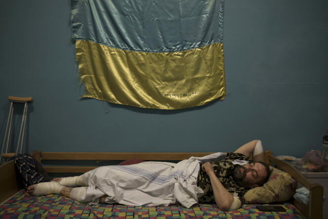 A Ukrainian commander rests after being wounded fighting Russian forces at a military hospital in Zaporizhzhya, Ukraine, April 2, 2022. 