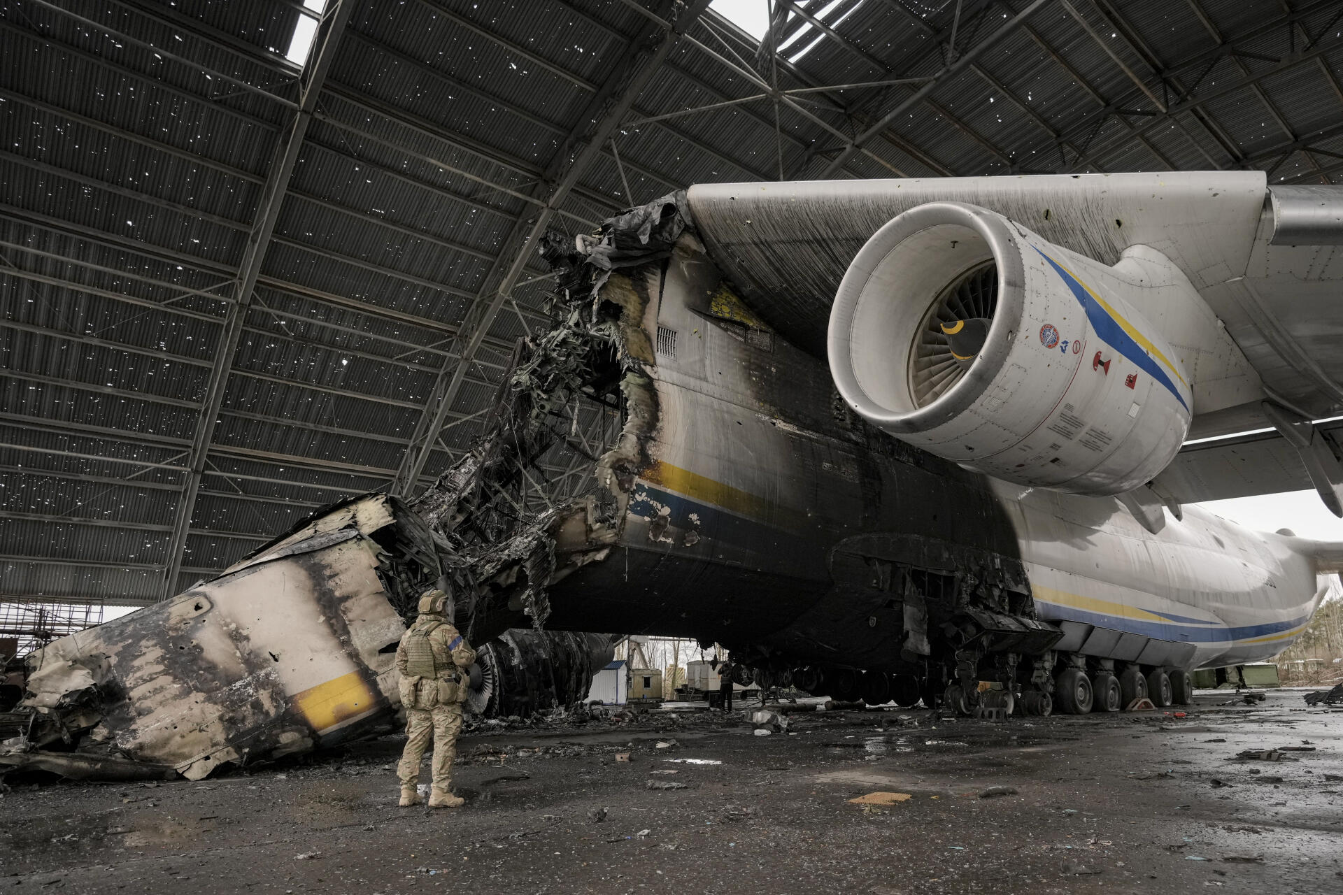 A Ukrainian soldier walks near a destroyed Antonov An-225 Mriya plane during fighting between Russian and Ukrainian forces at Antonov airport in Hostomel on Saturday (April 2).