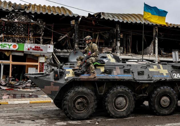 A Ukrainian soldier patrols a street in Boutcha, northwest of Kiev, in an armored vehicle on April 2.