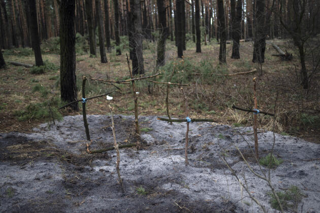 Crosses honoring civilians killed in fighting between Russian and Ukrainian forces mark a mass grave in the Irpine forest on the outskirts of Kiev on Saturday (April 2).