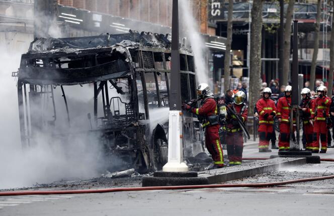 Firefighters work at the scene where a bus caught fire in Paris, France, April 4, 2022. REUTERS/Benoit Tessier