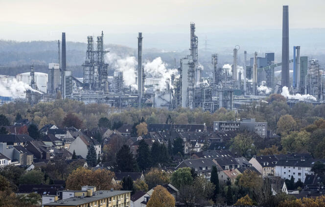Steam from a BP oil refinery rises behind houses in Gelsenkirchen, Germany, Nov. 5, 2021.