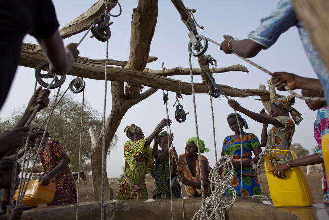 Women draw water from a well in the village of Kiral in the Matam region of northeastern Senegal, on May 1, 2022.