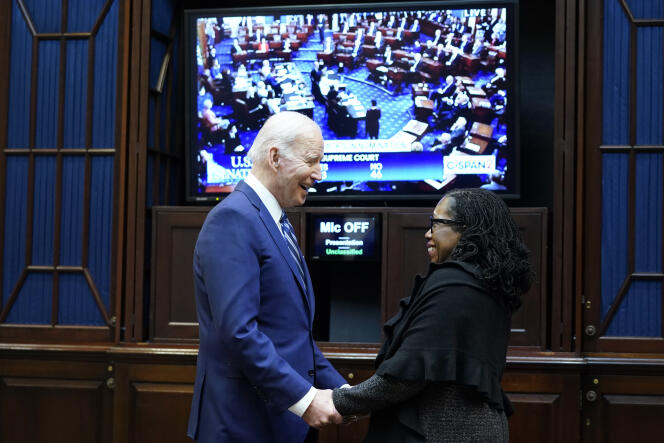 President Joe Biden talks with Supreme Court nominee Judge Ketanji Brown Jackson as they watch the Senate vote on her confirmation from the Roosevelt Room of the White House in Washington, Thursday, April 7, 2022.