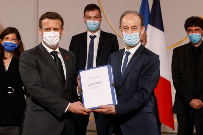 French President Emmanuel Macron and historian Vincent Duclert during the presentation of the report at the Elysée Palace in Paris on March 26, 2021.