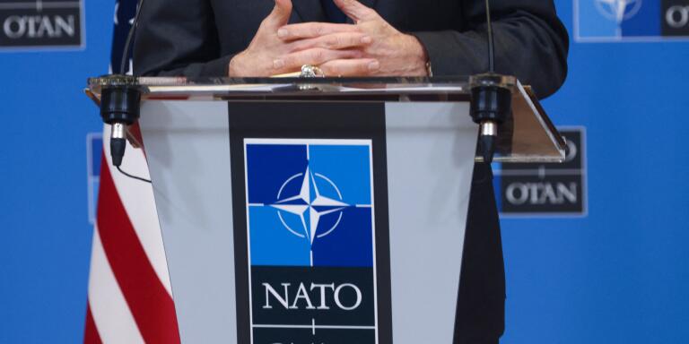 Hands of US Secretary of State Antony Blinken are seen as he speaks to the media after a NATO foreign ministers meeting, amid Russia's invasion of Ukraine, over the logo of NATO at its headquarters in Brussels, Belgium April 7, 2022. (Photo by EVELYN HOCKSTEIN / POOL / AFP)