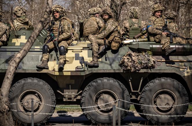 Ukrainian soldiers sit on an armored military vehicle in the city of Severodonetsk in the Donbas region on April 7, 2022, amid the Russian military invasion against Ukraine.