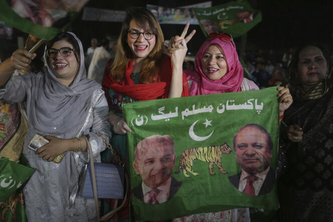 Supporters of newly elected Pakistani Prime Minister Shahbaz Sharif flash victory signs to celebrate outside their party's office, in Lahore, Pakistan, Monday, April 11, 2022.