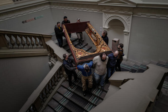 Employees of the Andrey Sheptytsky National Museum in Lviv, Ukraine, lower a fragment of an iconostasis (wall of Orthodox icons and paintings) in order to put it under cover, on March 7, 2022.