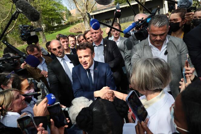 Emmanuel Macron talks with caregivers at the Alister center in Mulhouse, France, on April 12, 2022.