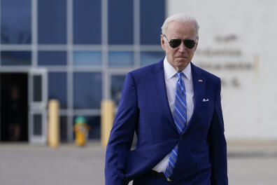 President Joe Biden walks to speak to reporters before boarding Air Force One at Des Moines International Airport, in Des Moines Iowa, Tuesday, April 12, 2022, en route to Washington. Biden said that Russia's war in Ukraine amounted to a "genocide," accusing President Vladimir Putin of trying to "wipe out the idea of even being a Ukrainian."(AP Photo/Carolyn Kaster)