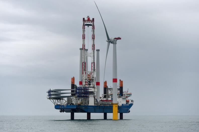 The jack-up vessel "Vole au Vent" assembles the first French off shore wind turbine in a wind farm, off Saint-Nazaire, western France, on April 12, 2022. - France's first offshore wind turbine has been installed in the Saint-Nazaire offshore park, an AFP journalist noted on April 12, 2022, for commissioning in early May. (Photo by Sebastien SALOM-GOMIS / AFP)