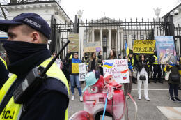 People attend a protest performance against the Russian invasion of Ukraine, in front of the Russian Embassy in Warsaw, Poland, Wednesday, April 13, 2022. (AP Photo/Czarek Sokolowski)
