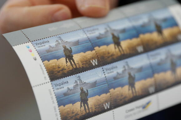 Ukraine Post CEO Igor Smilyansky holds postage stamps showing a Ukrainian soldier and a Russian warship depicting the guided-missile cruiser 'Moskva', which sank Thursday, at the company's headquarters in Kyiv, Ukraine on April 14, 2022.