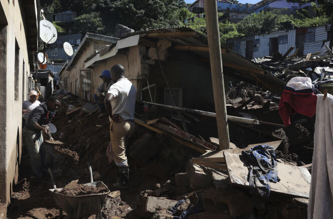 People clean up damaged houses after floods in Clermont township, Durban, South Africa, April 14, 2022.