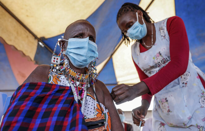 A Maasai woman receives the AstraZeneca coronavirus vaccine at a clinic in Kimana, southern Kenya, on August 28, 2021.