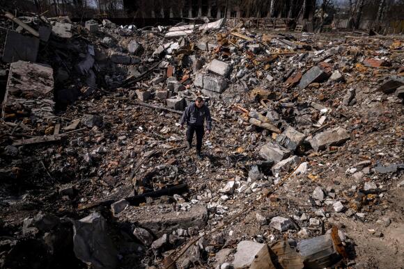 A policeman walks among the rubble of destroyed houses in the village of Borodianka, northeast of Kyiv, on April 14, 2022.