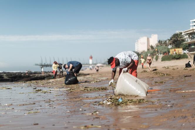 Volunteers clean up the beach in Durban on April 15, 2022.
