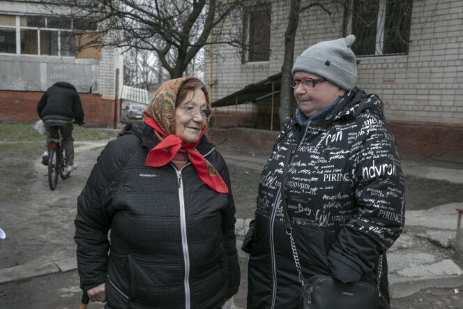 Galyna Tchiyenok and Elena Pazniak at the foot of their building in Chernihiv, Ukraine, April 12, 2022.