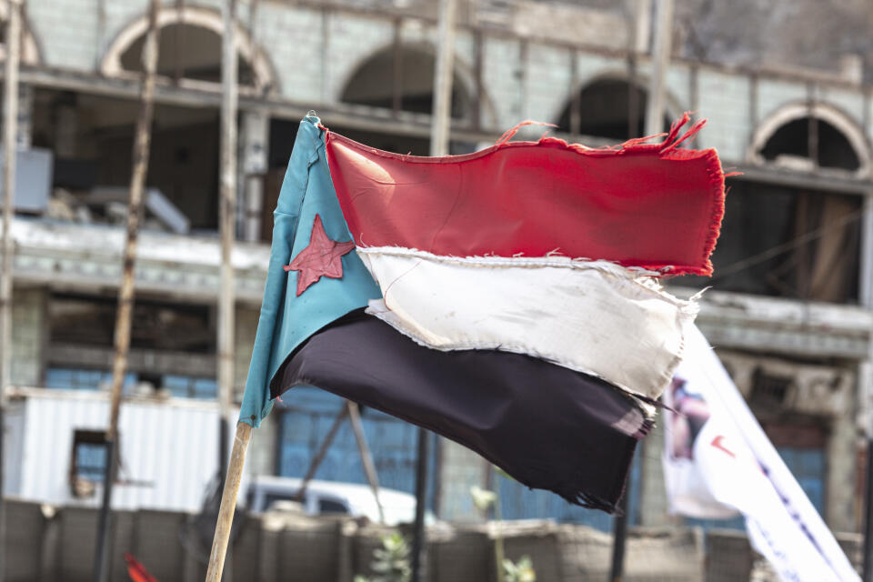 ADEN, YEMEN - FEBRUARY 21: A Southern Transitional Council (STC) flag at a military checkpoint in Aden, Yemen, on February 21, 2022. The blue triangle marks the flag of South Yemen. The STC, a separatist movement who want to see southern Yemen become an autonomous state are supported by the United Arab Emirates and wrested control of Aden from their ostensible allies, the Saudi-backed government of Yemen, for whom Aden is their current capital, after days of clashes and airstrikes in August 2019. Now the two exist side-by-side in an uneasy power sharing agreement. Aden is currently the temporary capital city of Yemen, according to the internationally recognized government, while Sana'a is controlled by the Houthi Ansar Allah. MANDATORY CREDIT: (Photo by Sam Tarling/Sana'a Center for Strategic Studies)