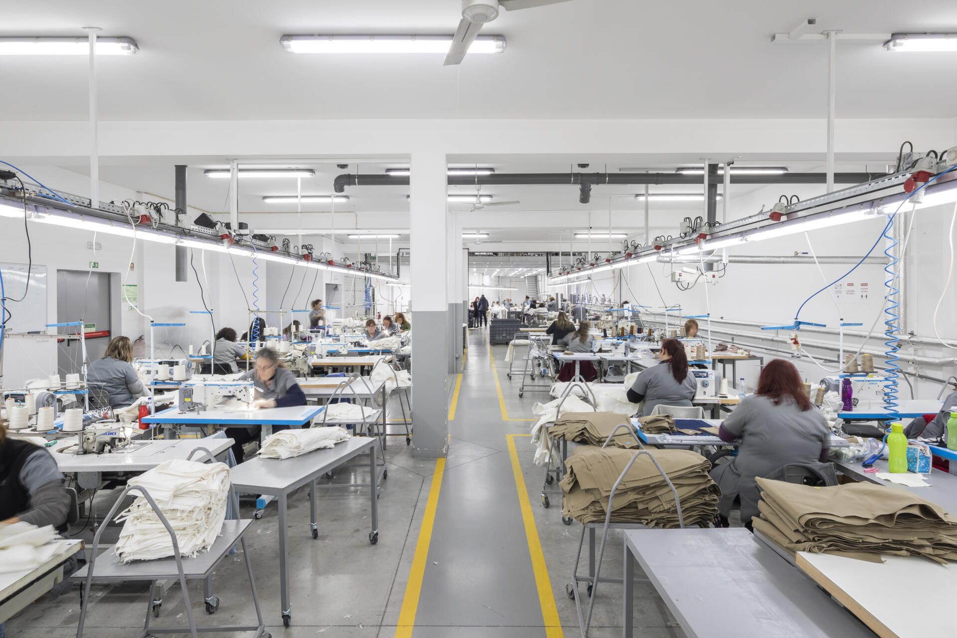 The factory has 3 production lines.  Each seamstress takes care of a part of the room, doing different types of sewing.  In Esmeriz, Portugal, on April 4, 2022.