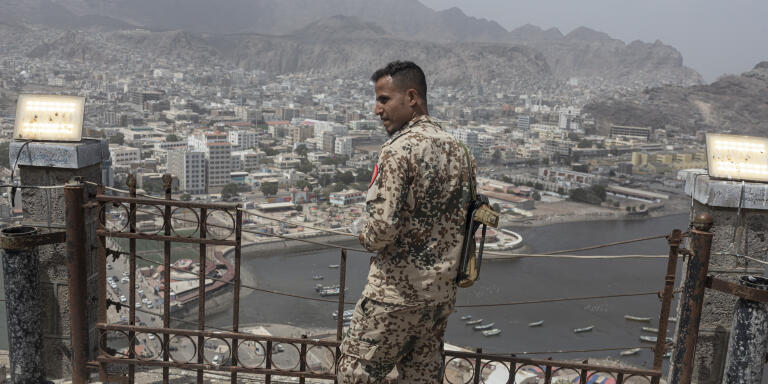 ADEN, YEMEN - FEBRUARY 24: A Southern Transitional Council soldier looks out over Aden from Sira Fortress, Yemen, on February 24, 2022. The temporary capital of the internationally recognised government of Yemen, Aden was targeted by airstrikes during the occupation of the city by Ansar Allah in 2015. It also saw heavy fighting in 2019 as the UAE-backed separatists the Southern Transitional Council wrested control from their ostensible allies, the Saudi-backed government of Yemen. Recently, fighting broke out between the Southern Transitional Council and a local warlord. Very little of the damage caused has been repaired. MANDATORY CREDIT: (Photo by Sam Tarling/Sanaa Center for Strategic Studies)