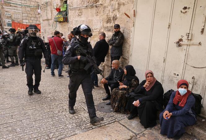 Israeli border police patrol in front of the Lion's Gate in Jerusalem's Old City, as Palestinians wait to be allowed to enter the al-Aqsa mosque compound, on April 17, 2022. 