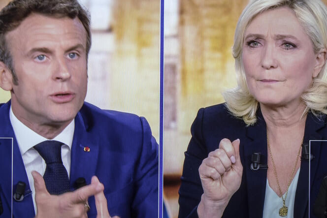 A picture shows screens displaying a live televised debate between French President and candidate for re-election Emmanuel Macron and far-right presidential candidate Marine Le Pen, broadcasted om French TV channels TF1 and France 2, on Wednesday, April 20. 