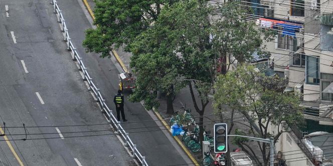 Un policier posté dans une rue de Shanghaï, lors du confinement, le 20 avril 2022.