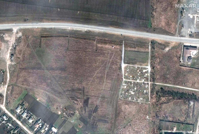 This satellite image provided by Maxar Technologies on Thursday, April 21, 2022 shows an overview of the cemetery in Manhush, some 20 kilometers west of Mariupol, Ukraine. 
