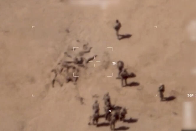 Image of the French army showing white soldiers covering a dozen bodies with sand, near the Gossi military base in Mali.