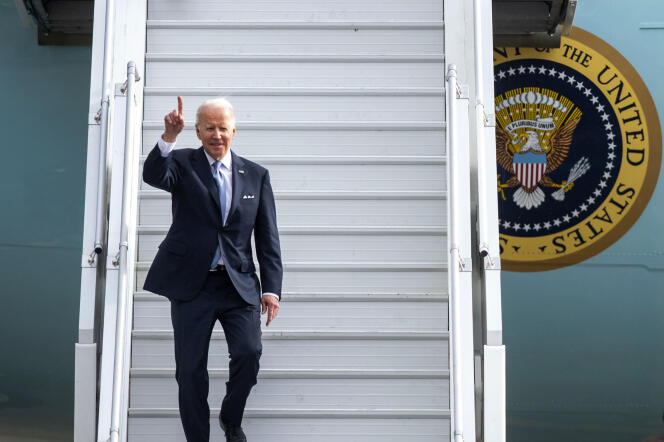 President Joe Biden waves to the media as he walks off of Air Force One on Thursday, April 21.