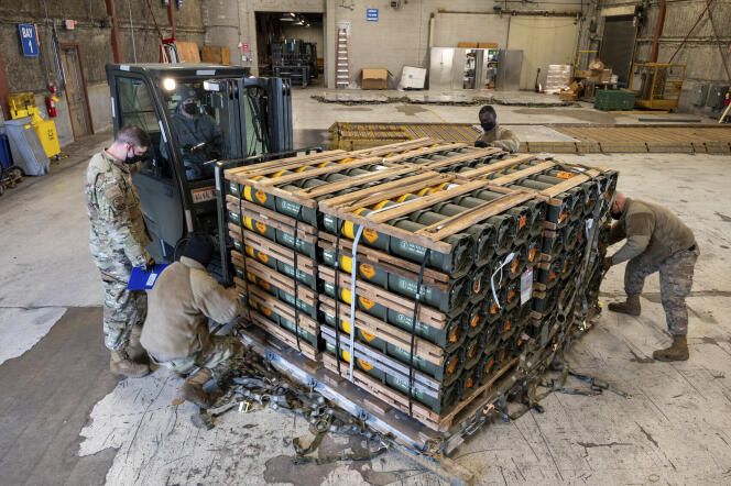 In this photo provided by the US Air Force, pilots and civilians from the 436th Airfield Squadron transport munitions, weapons, and other equipment destined for Ukraine during an overseas materiel sale mission at Dover Air Force Base, Jan. 21, 2022. 
