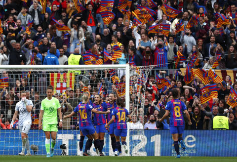 Barcelona's Alexia Putellas celebrates with teammates after scoring her sides fourth goal during the Women's Champions League semifinal, first leg soccer match between Barcelona and Wolfsburg at Camp Nou stadium in Barcelona, Spain, Friday, April 22, 2022. (AP Photo/Joan Monfort)