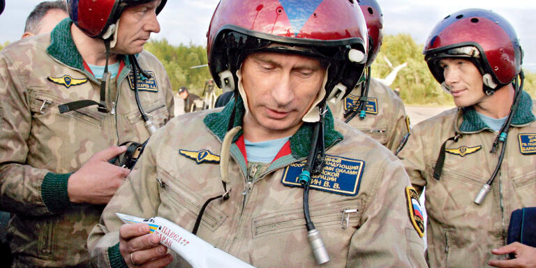 Russian President Vladimir Putin looks over a model of TU-160 strategic bomber 'Pavel Taran' which carried him to the air field of Olenegorsk, in Murmansk region, Russia, on August 16, 2005. Photo by Alexei Panov/ITAR-TASS/ABACAPRESS.COM.