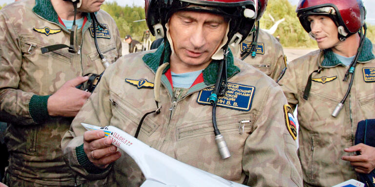 Russian President Vladimir Putin looks over a model of TU-160 strategic bomber 'Pavel Taran' which carried him to the air field of Olenegorsk, in Murmansk region, Russia, on August 16, 2005. Photo by Alexei Panov/ITAR-TASS/ABACAPRESS.COM.